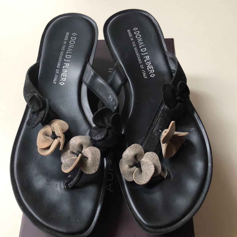 Donald Pliner flip-flops with Rosette detailing.